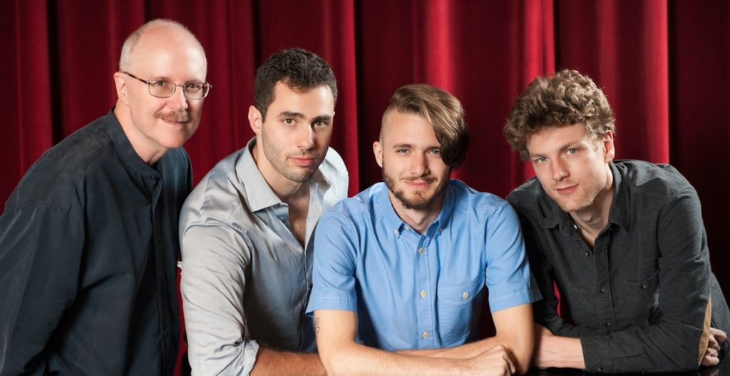 Contemporary quartet Otherworld poses for a press photo on stage