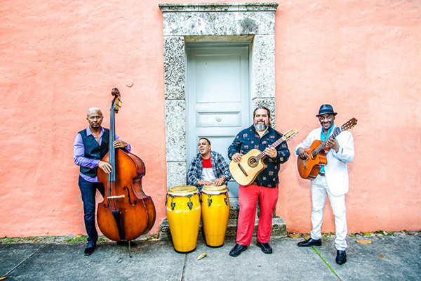 Press photo of Cuban music group Cortadito with their instruments