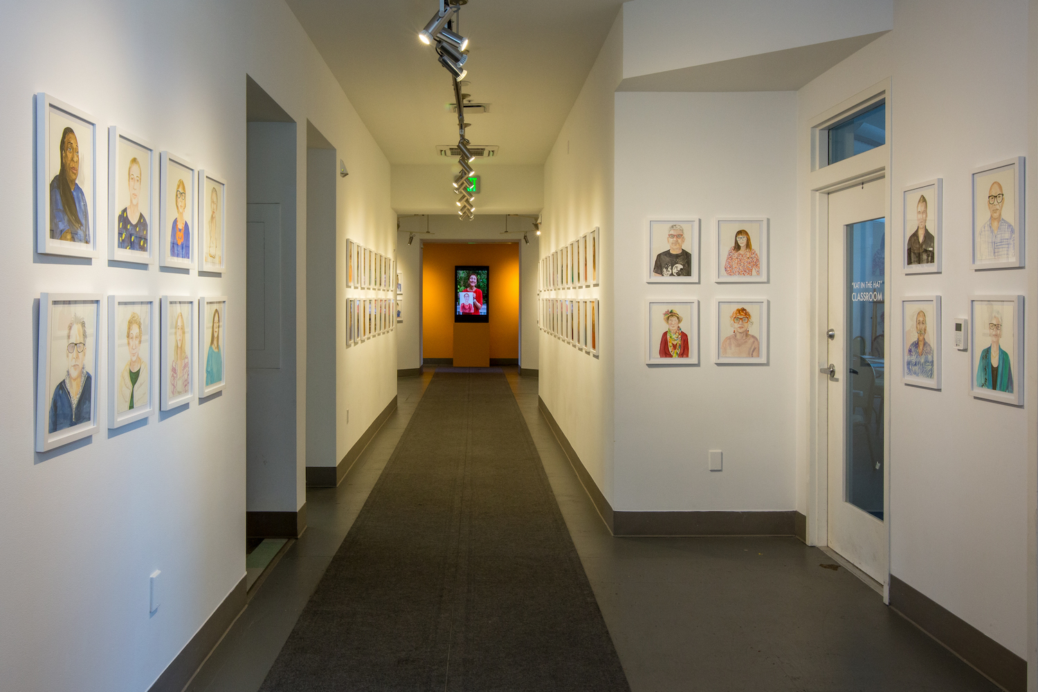 101 portraits on display in a gallery