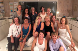 Group of 13 women posing for a photo
