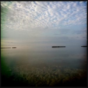 Artwork of the clouds and sun over the ocean