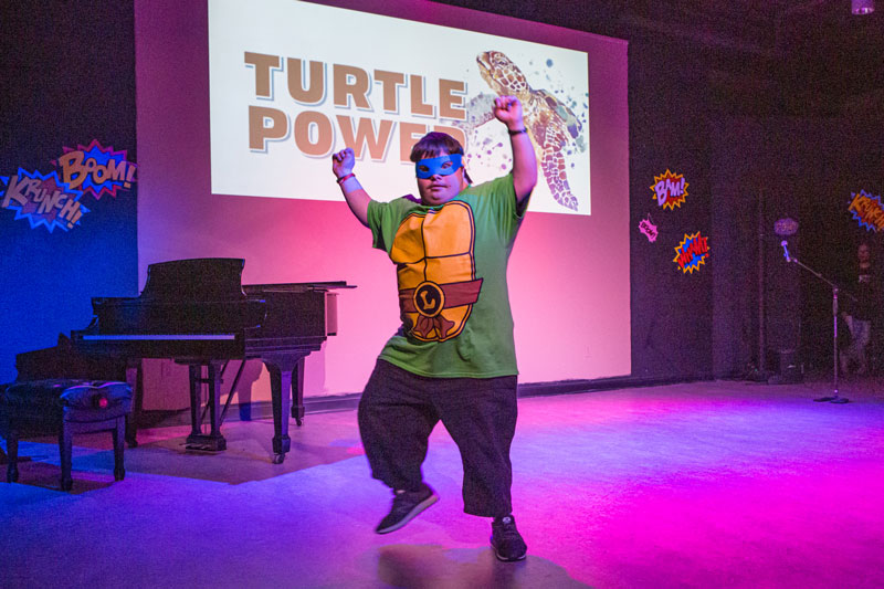 Man dancing as a teenage mutant ninja turtle outfit
