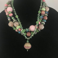 Triple strand necklace of pink, green, and blue beads