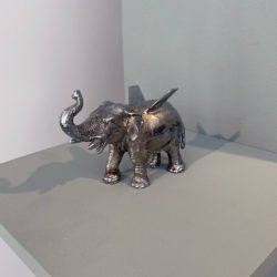 Chrome plated bronze elephant with small airplane wings extending from it's back