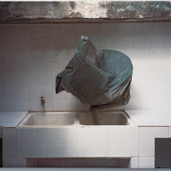 Functional TV satellite, covered in a trash bag, resting in a sink