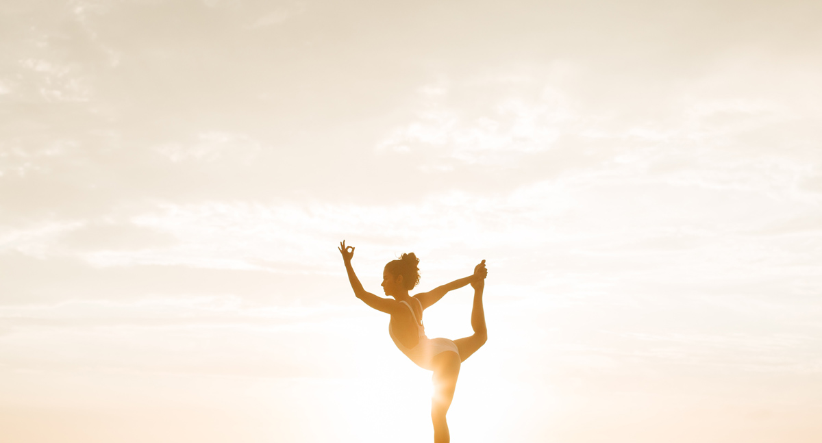 photo of woman in dancer Yoga pose for Rooftop Yoga November 2021 classes with Lea Moeller