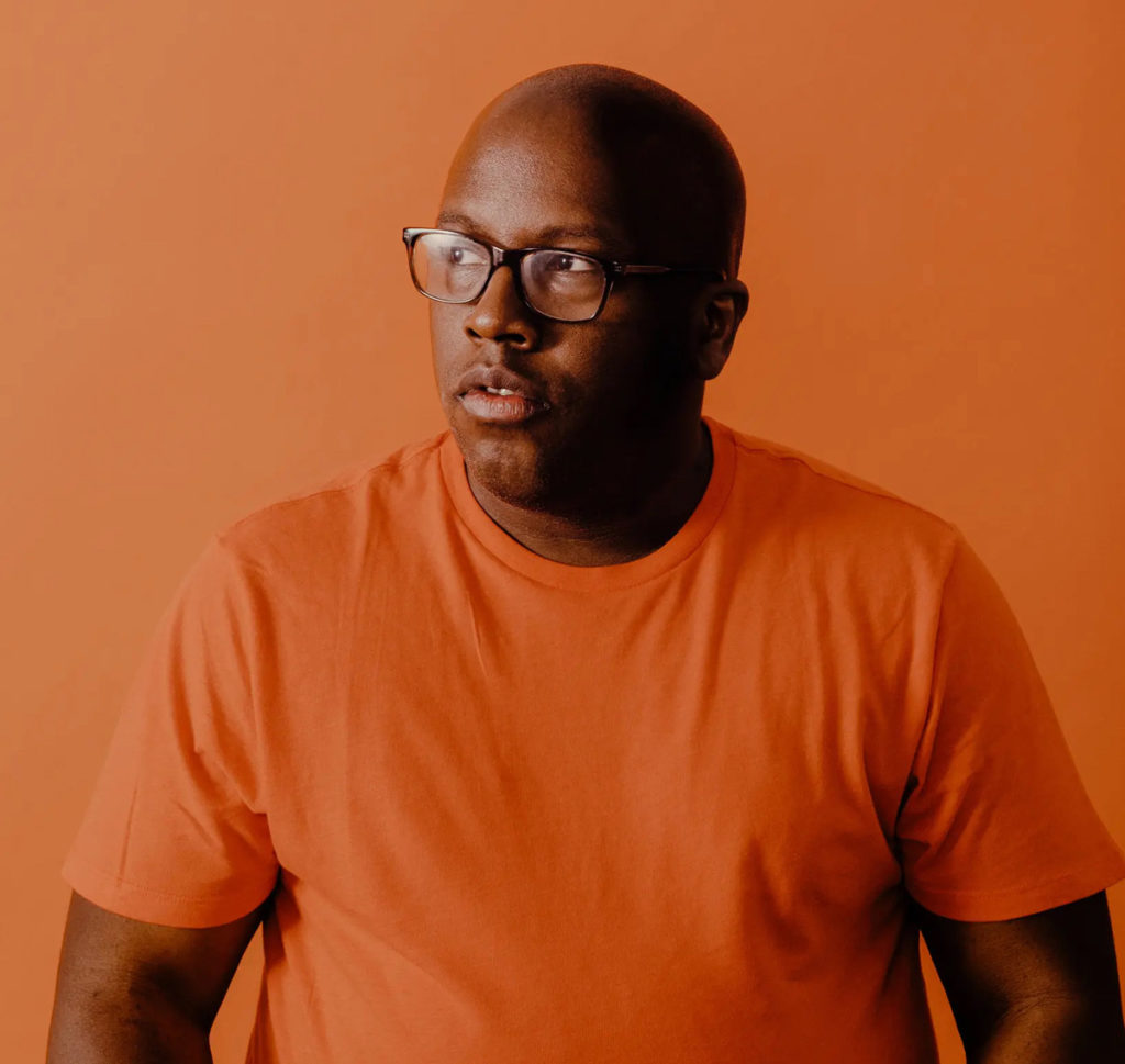 Actor Michael R. Jackson from Between Two Palms dressed on orange t-shirt against orange backgroun.