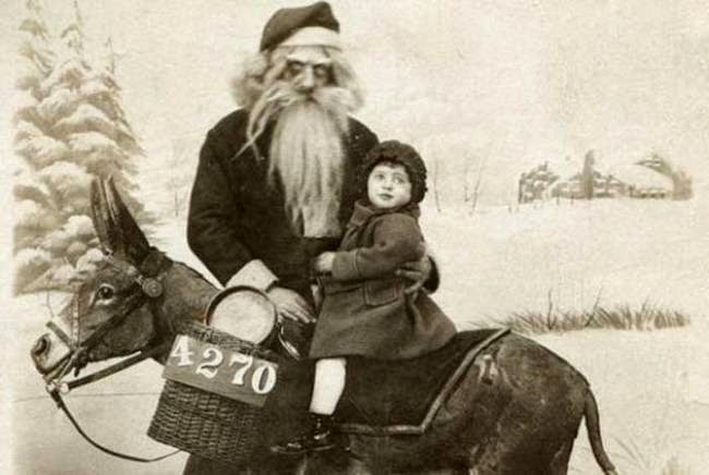 Sepia tone image of a creepy Santa and young girl riding a donkey.