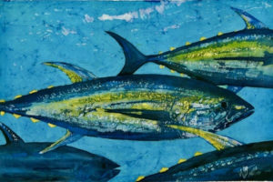 School of tuna fish drawn on fabric in blue, yellow and green waxes and dyes.