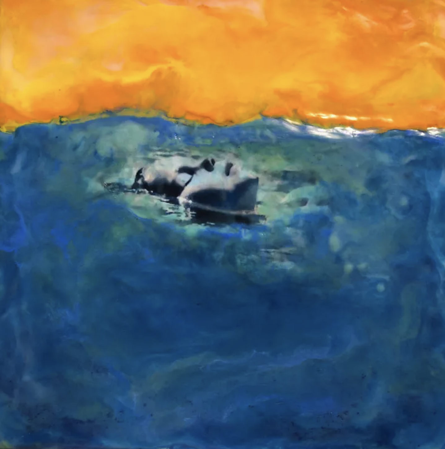 Encaustic work of a child's face floating in blue water with an orange and yellow sky.