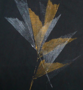Fishtail palm dipped in metallic inks to create a nature print on black fabric.