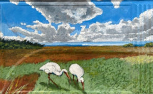 Painted roof tile of two cranes walking and eating from tall grass with sunny but cloudy sky and mangroves in the background.
