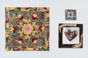 Quilting-inspired techniques in different media. Ellis works in fiber, creating intricate seams and Antonides explores patchwork through unexpected materials.