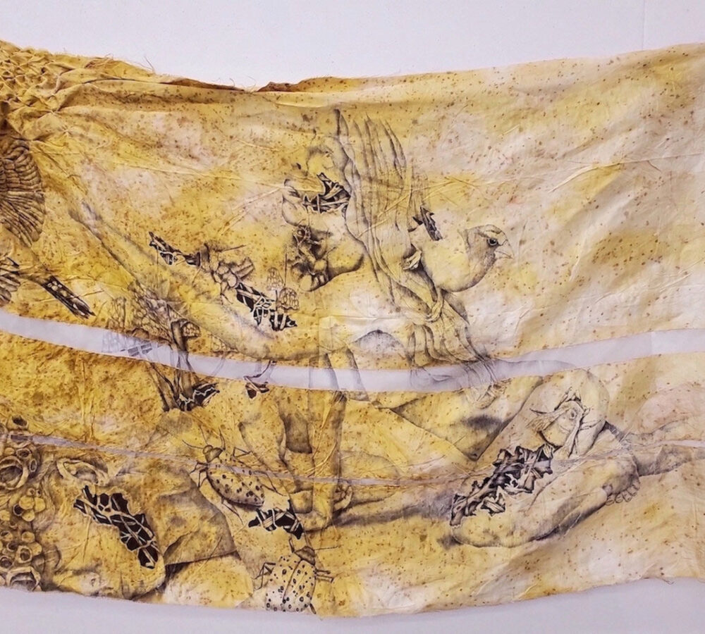 Large yellow-toned fabric piece featuring delicate line drawings of reclining figures, insects, and birds, creating a dreamlike composition.