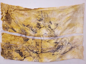 Large yellow-toned fabric piece featuring delicate line drawings of reclining figures, insects, and birds, creating a dreamlike composition.