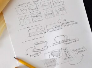 Sketchbook page showing pencil studies of bowls, cups, and landscapes with perspective notes.
