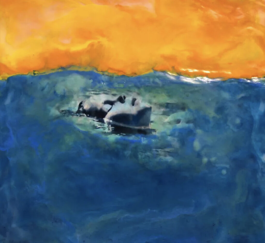 Painting of a face floating serenely in deep blue water beneath a glowing orange sky, blending realism with dreamy abstraction.
