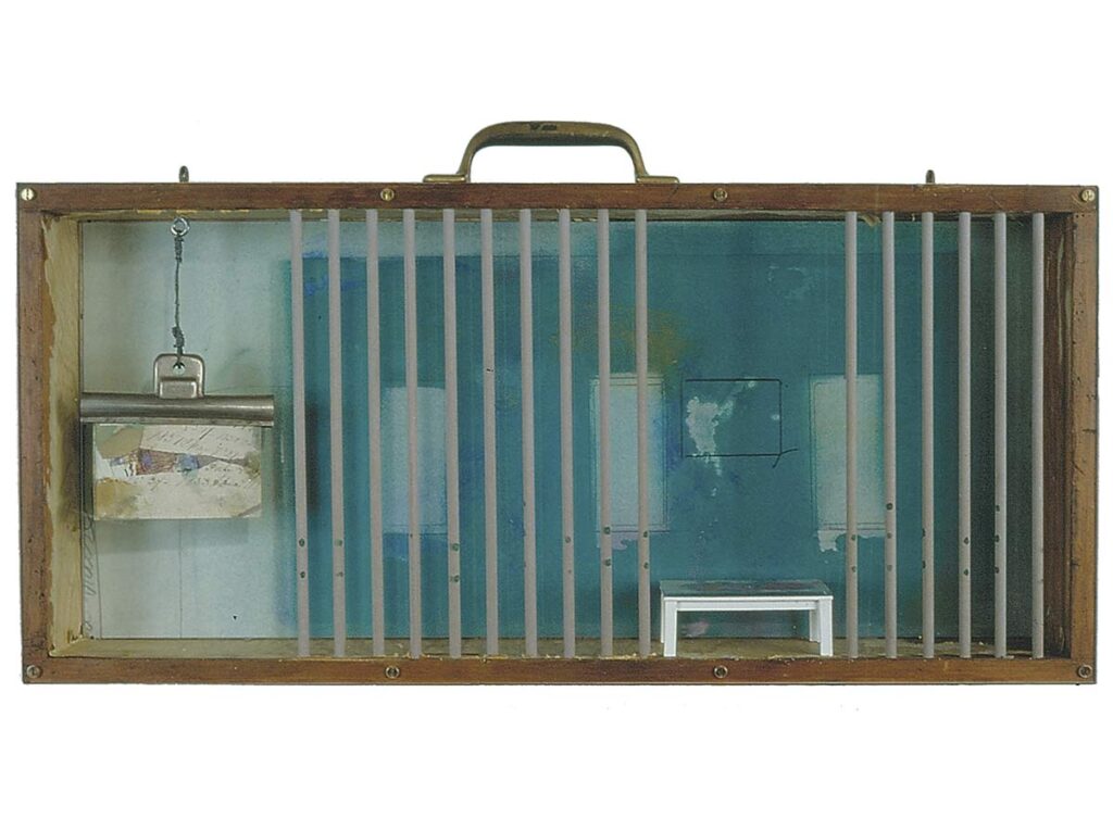 Shadowbox artwork with vertical rods, layered blue panels, and suspended miniature paper elements.