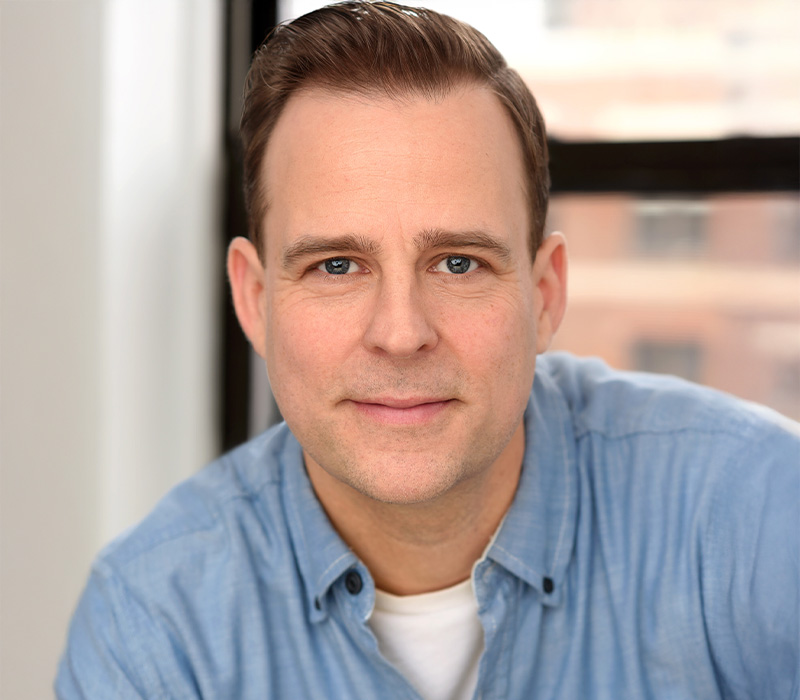 Matt Hopkins Headshot of Matt Hopkins in a light blue shirt, smiling slightly against an indoor background.