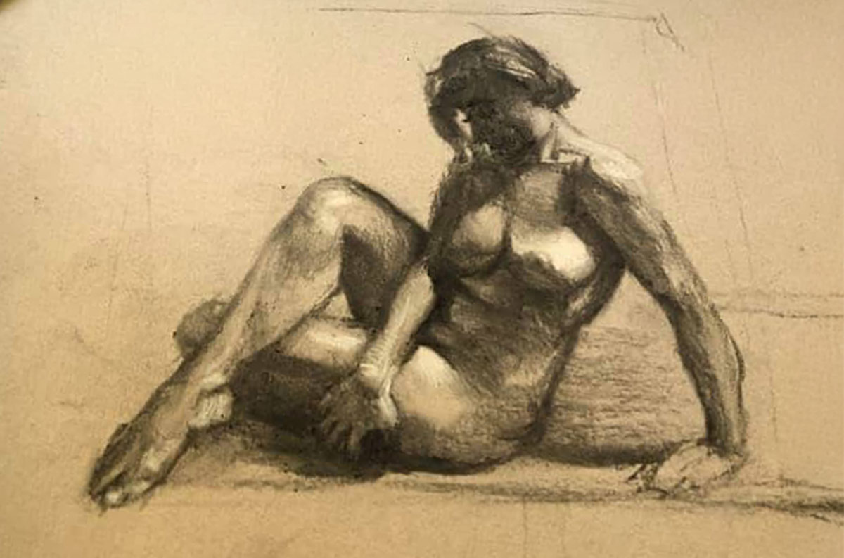 Charcoal figure drawing of a reclining nude model posed on the floor, rendered with soft shading and visible sketch lines against a neutral background.