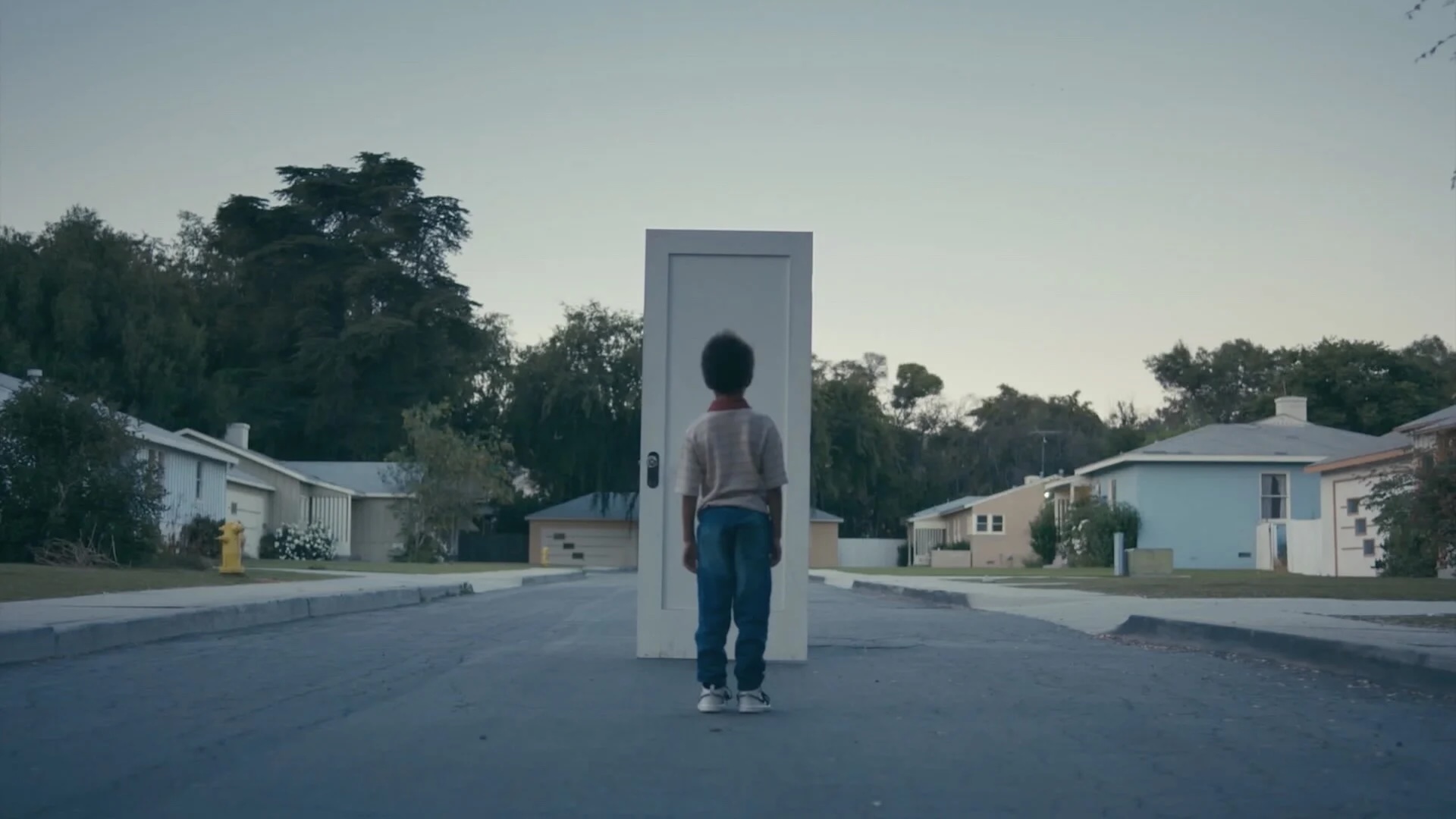boy standing in front of door
